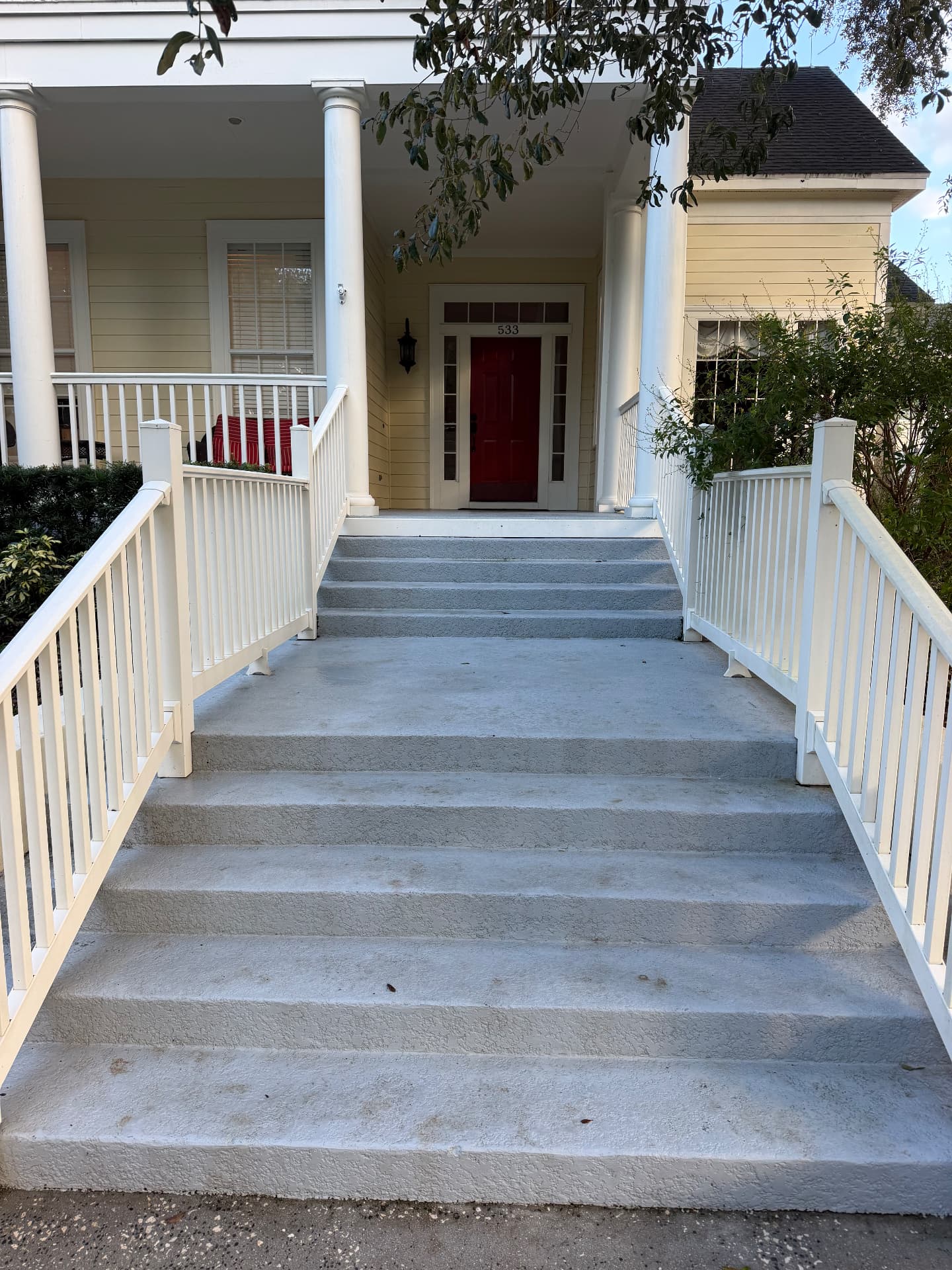 The same front entry steps and landing cleaned bright and free of mildew after pressure washing