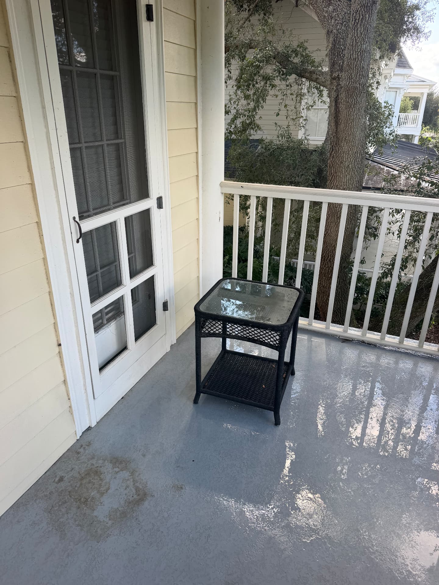 The same upper balcony floor freshly rinsed and clean after pressure washing